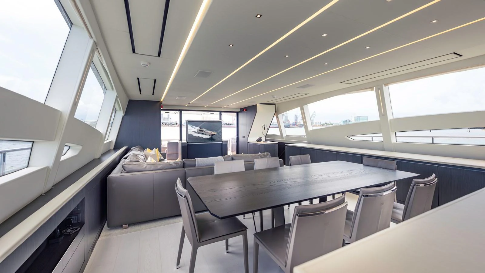 The spacious salon features modern furnishings and panoramic windows, offering a luxurious and comfortable setting. aboard ANDIAMO II Yacht for Sale