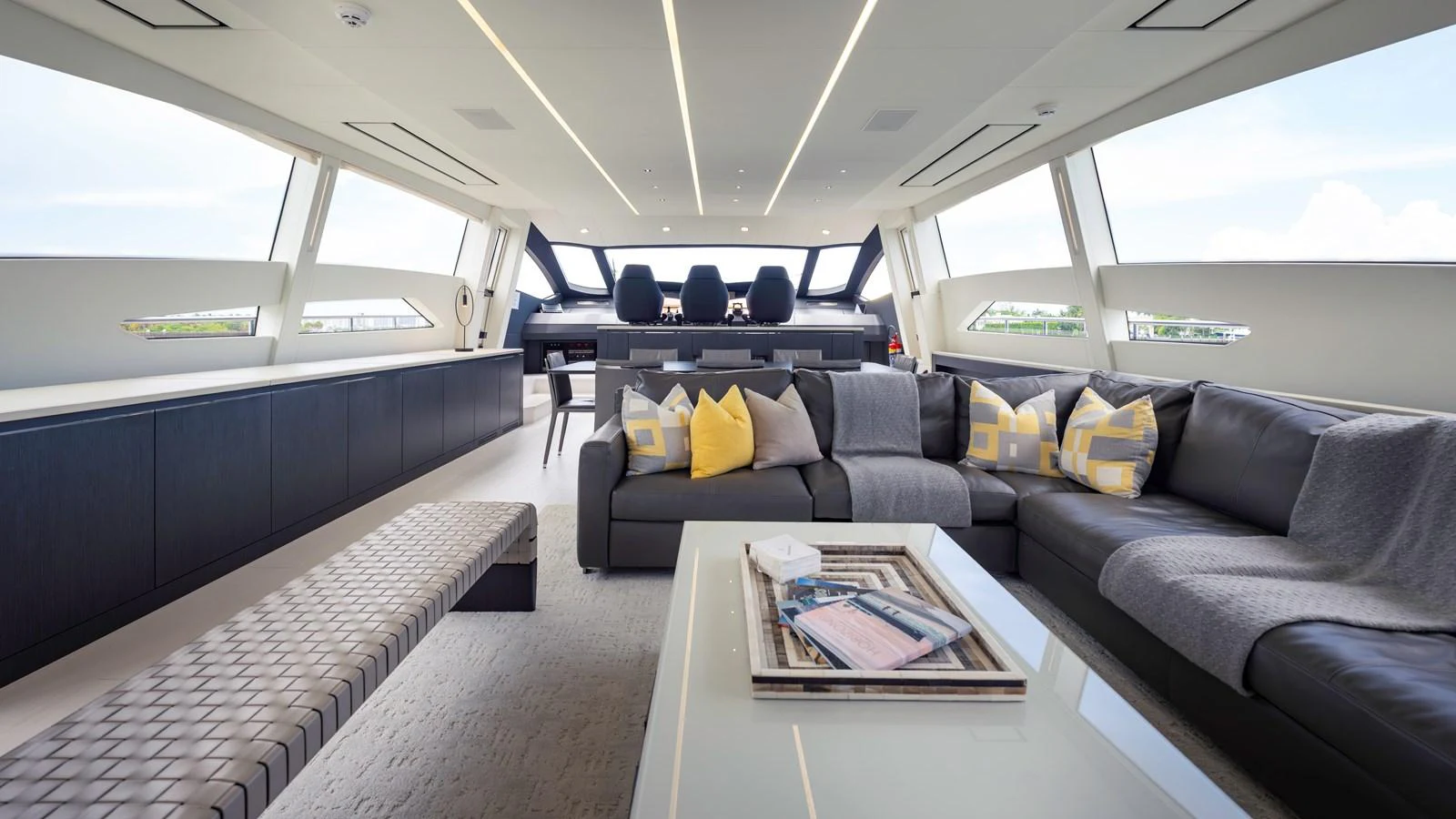 The salon features a spacious and modern seating area with large windows providing ample natural light. aboard ANDIAMO II Yacht for Sale
