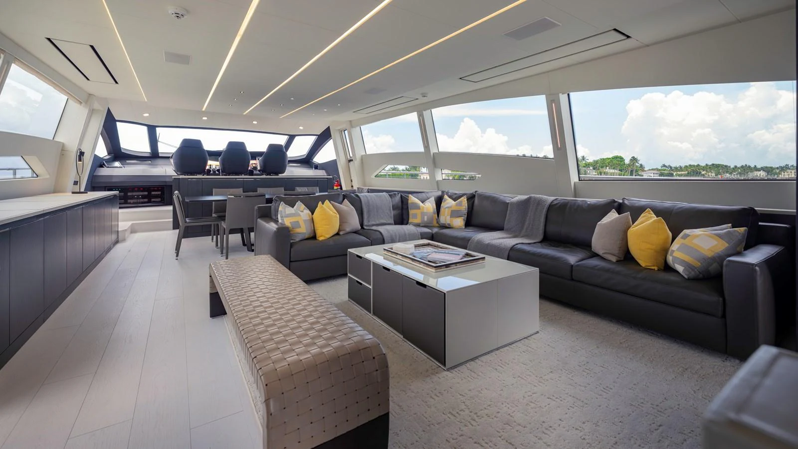 The spacious salon features modern furnishings and large windows offering panoramic views. aboard ANDIAMO II Yacht for Sale