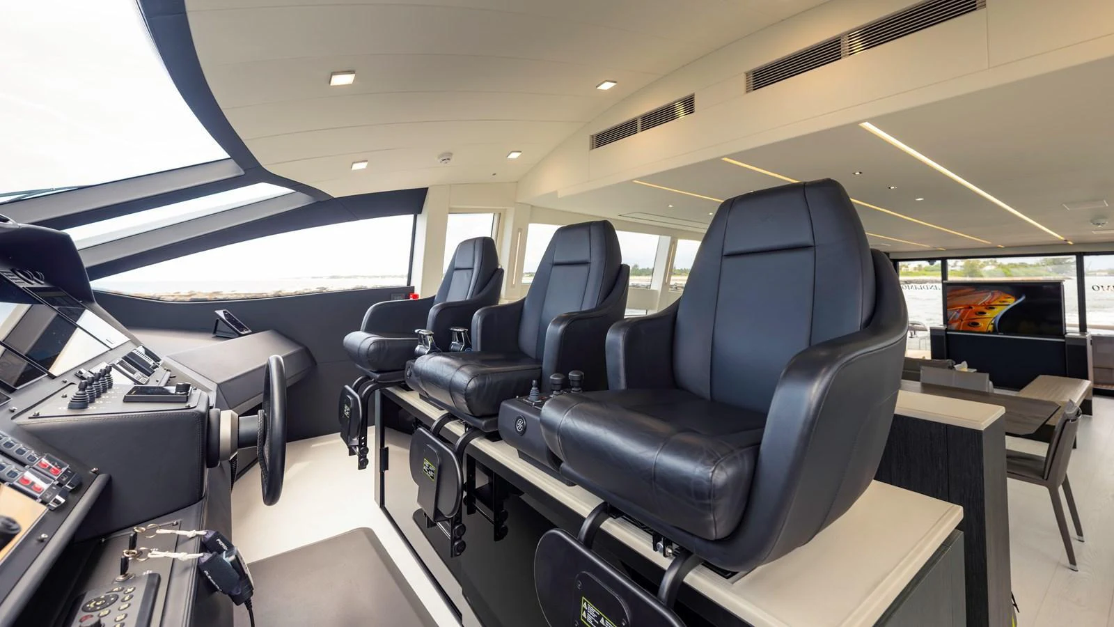The helm area features modern, comfortable seating with a sleek design. aboard ANDIAMO II Yacht for Sale