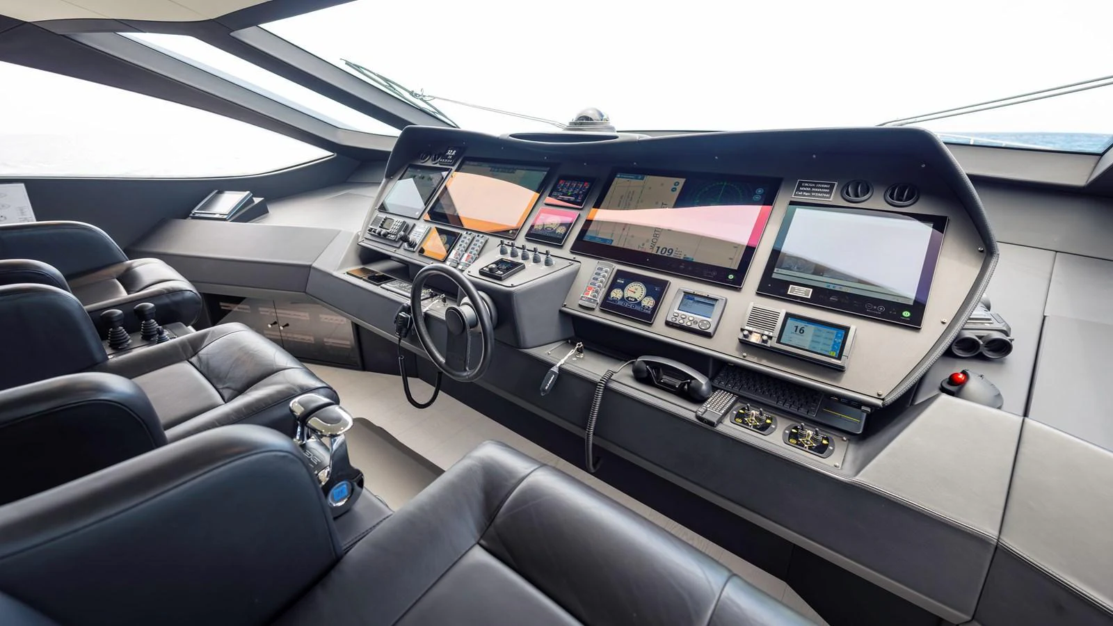 The helm station features advanced navigation systems and luxurious seating for optimal control and comfort. aboard ANDIAMO II Yacht for Sale