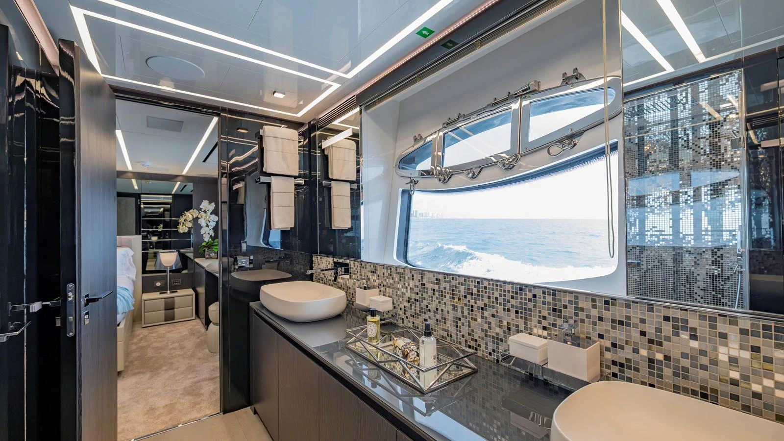 A luxurious yacht bathroom with modern fixtures and a large window offering a stunning ocean view. aboard ANDIAMO II Yacht for Sale