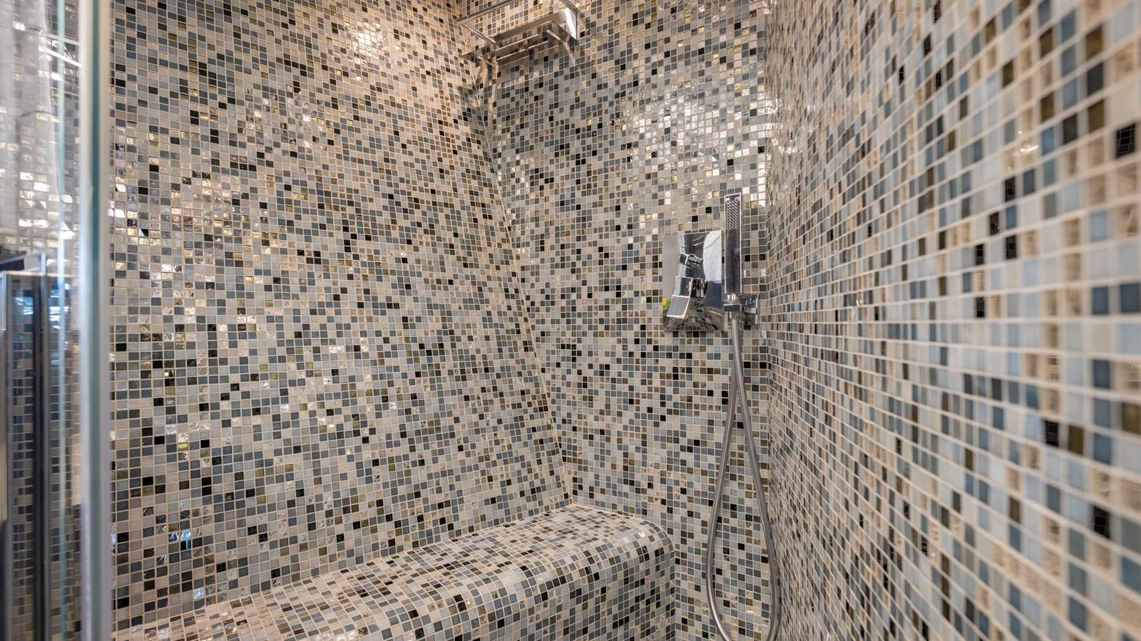 The yacht features a luxurious shower with intricate mosaic tilework. aboard ANDIAMO II Yacht for Sale