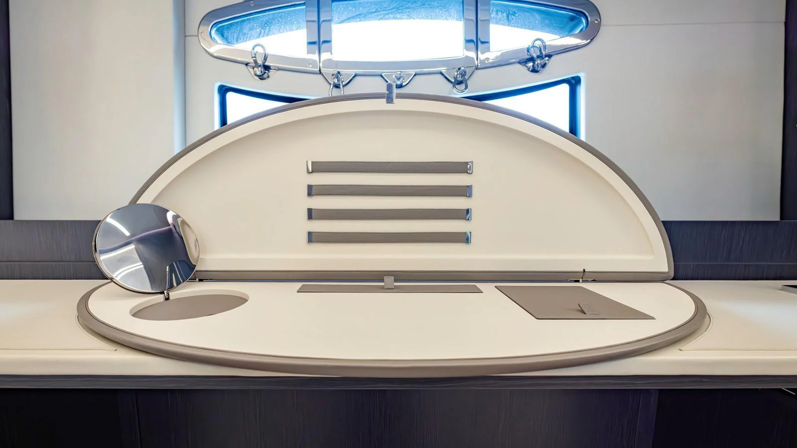 A sleek and modern interior detail featuring a built-in vanity with a mirror and storage compartments. aboard ANDIAMO II Yacht for Sale