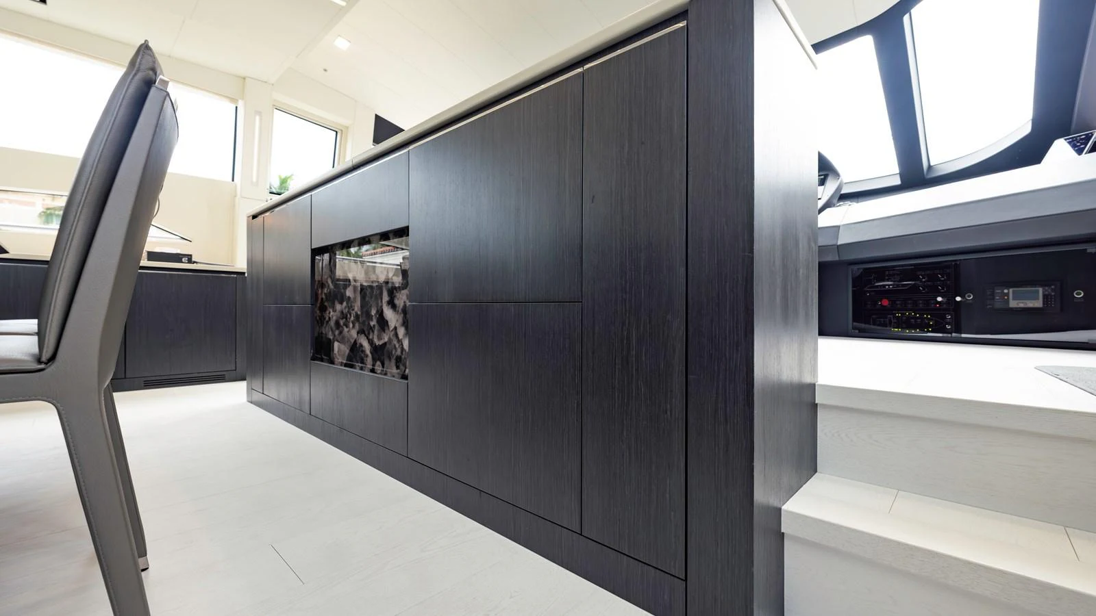 The yacht's interior features sleek, modern cabinetry and a well-lit space. aboard ANDIAMO II Yacht for Sale