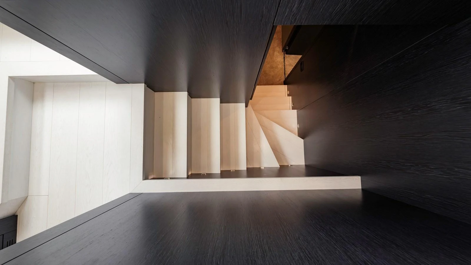 A sleek and modern staircase with contrasting dark and light tones. aboard ANDIAMO II Yacht for Sale