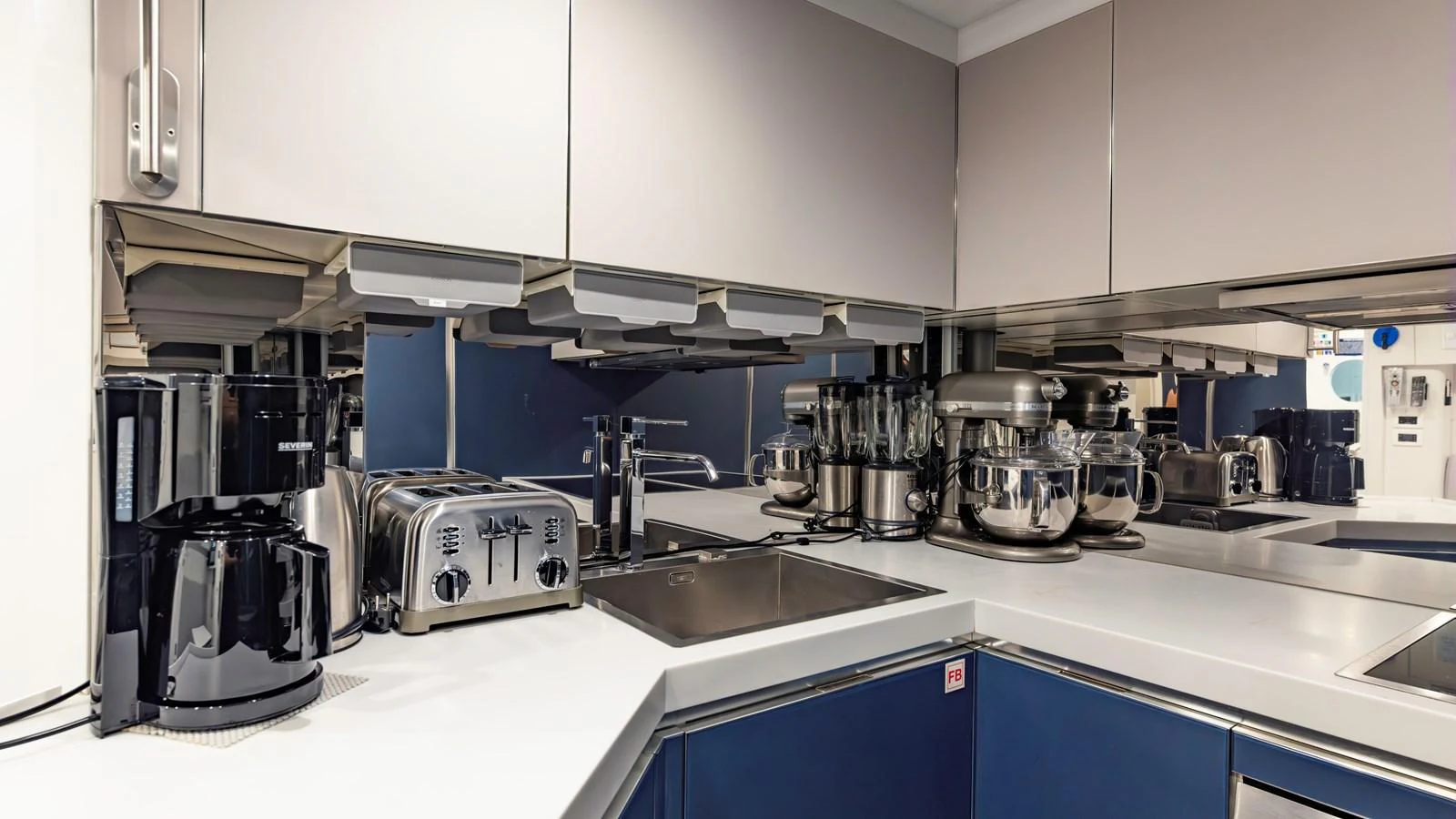 The yacht's galley is equipped with modern appliances and sleek countertops, perfect for gourmet cooking at sea. aboard ANDIAMO II Yacht for Sale