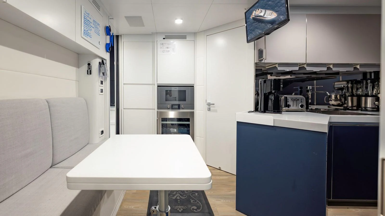 The yacht's galley features modern appliances and a cozy dining area. aboard ANDIAMO II Yacht for Sale