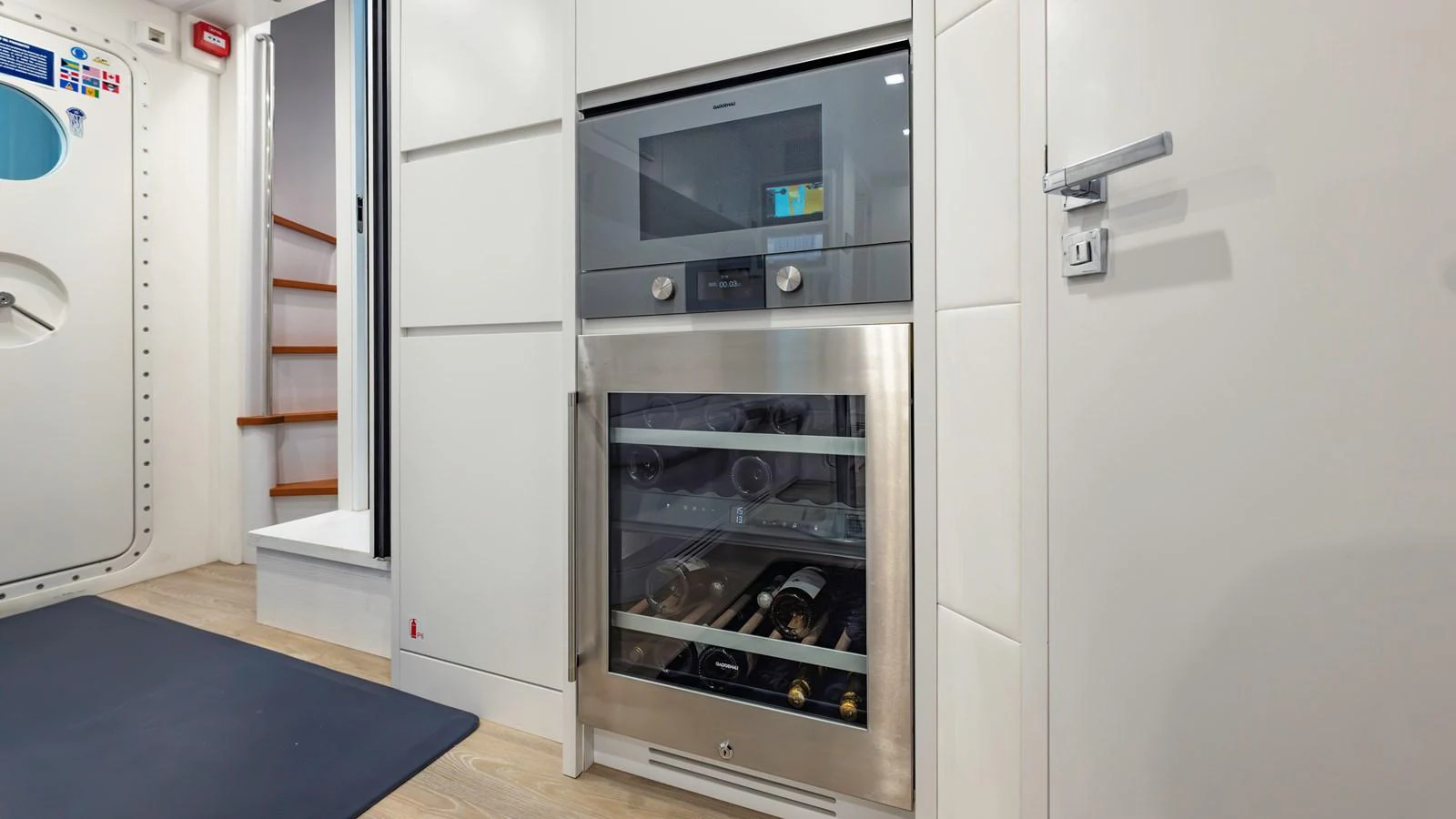 The yacht's galley features a modern oven and wine cooler, showcasing its well-equipped culinary space. aboard ANDIAMO II Yacht for Sale