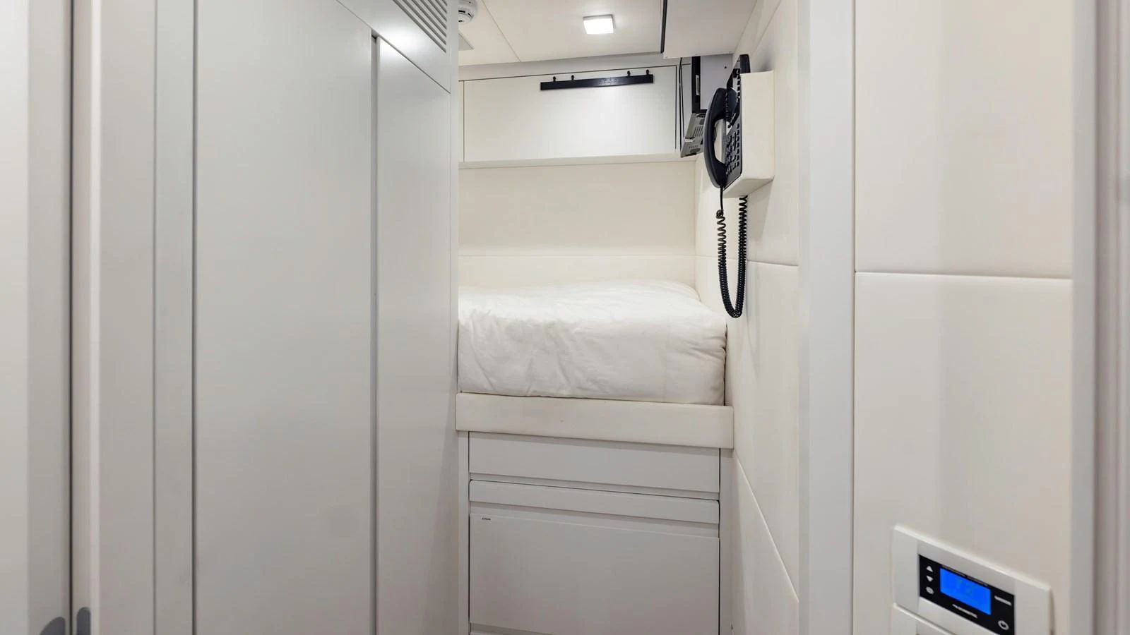 A compact and functional crew cabin with a single bed and essential amenities. aboard ANDIAMO II Yacht for Sale