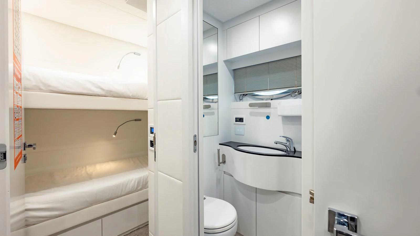 The image showcases a compact and modern guest cabin with bunk beds and an en-suite bathroom. aboard ANDIAMO II Yacht for Sale