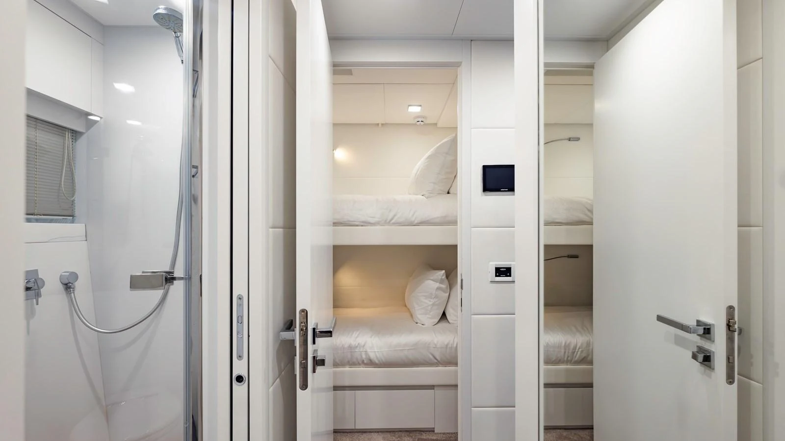 The image showcases a compact and modern bunk room with clean lines and a minimalist design. aboard ANDIAMO II Yacht for Sale