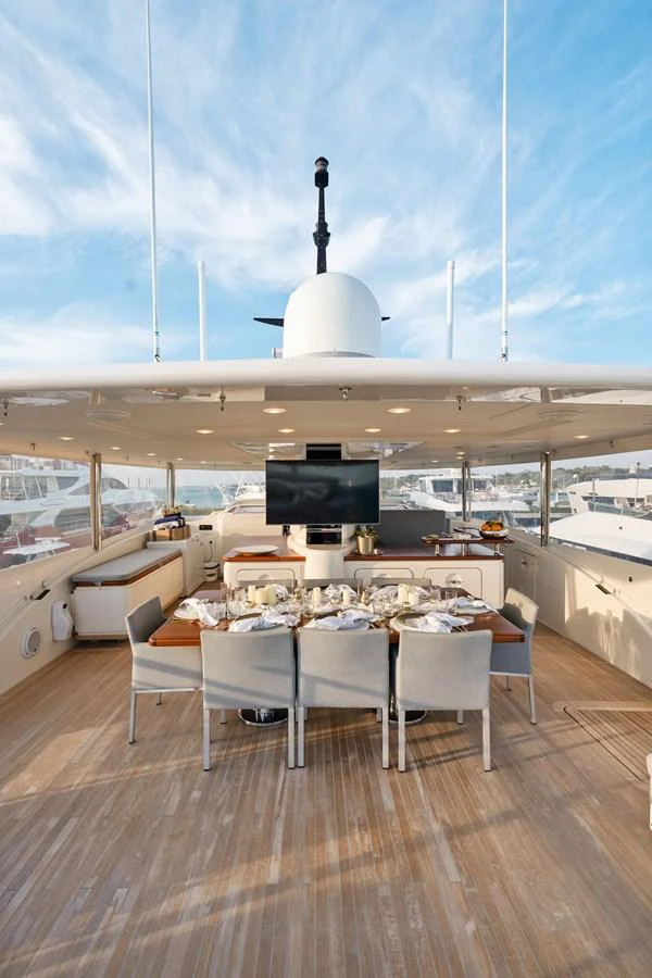 a table with chairs and a television on it aboard FONTANA Yacht for Sale