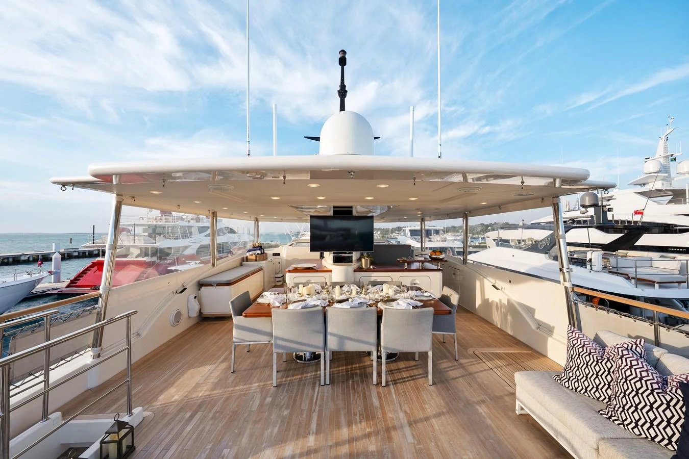 a deck with a table and chairs on it aboard FONTANA Yacht for Sale