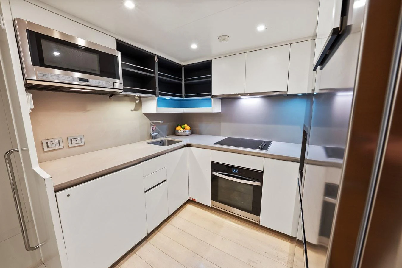 a kitchen with white cabinets aboard FONTANA Yacht for Sale