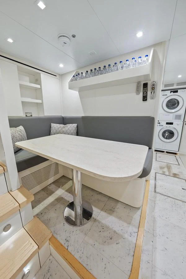 a kitchen with a bar and a table aboard FONTANA Yacht for Sale