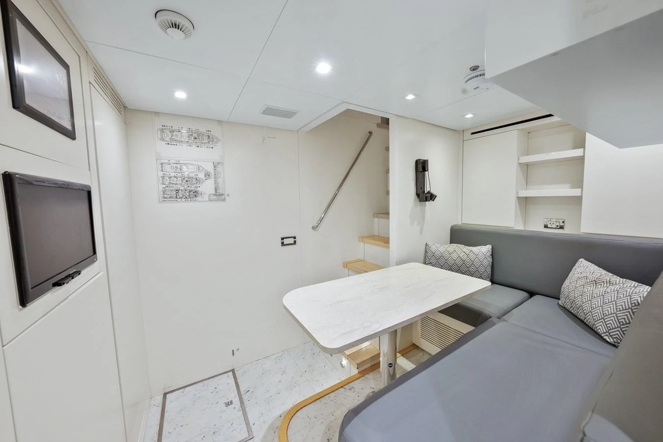 a living room with a couch and a television aboard FONTANA Yacht for Sale