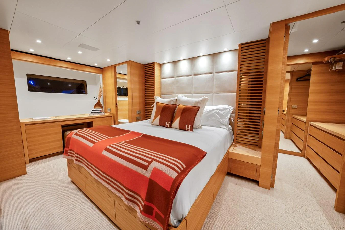 a bedroom with a bed and a wood closet aboard FONTANA Yacht for Sale