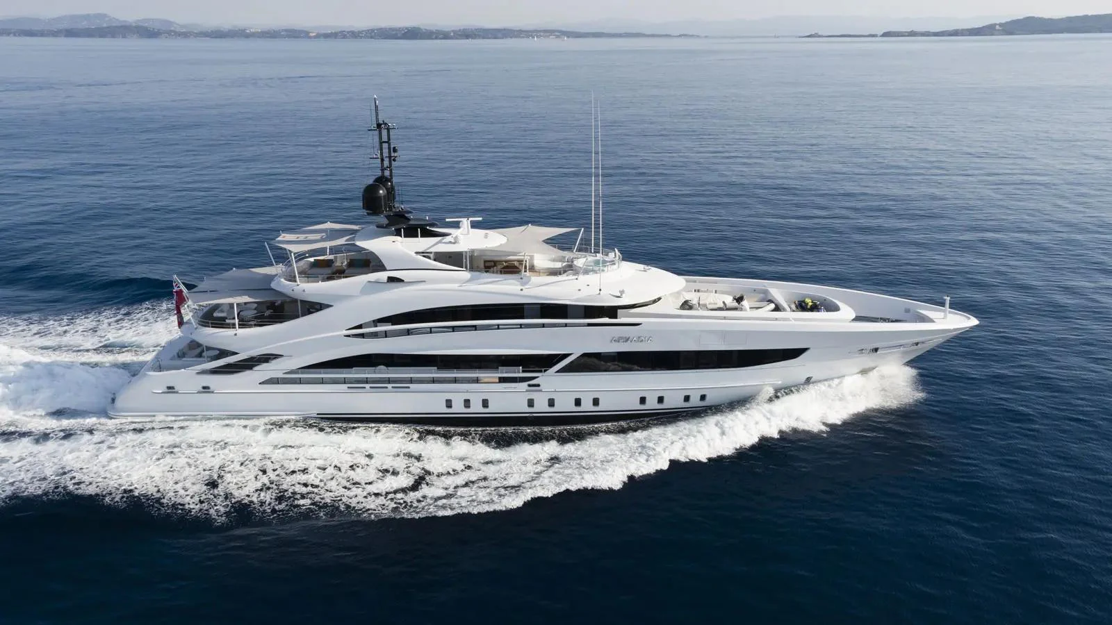 A sleek and modern yacht glides effortlessly through calm waters, showcasing its elegant design and luxurious amenities. aboard ARKADIA Yacht for Sale