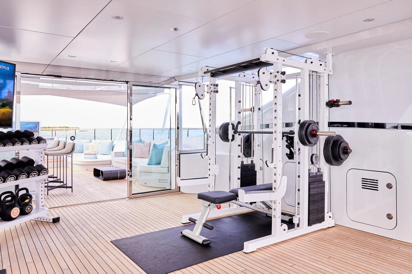 The yacht features a well-equipped gym with modern fitness equipment and a view of the sea. aboard ARKADIA Yacht for Sale