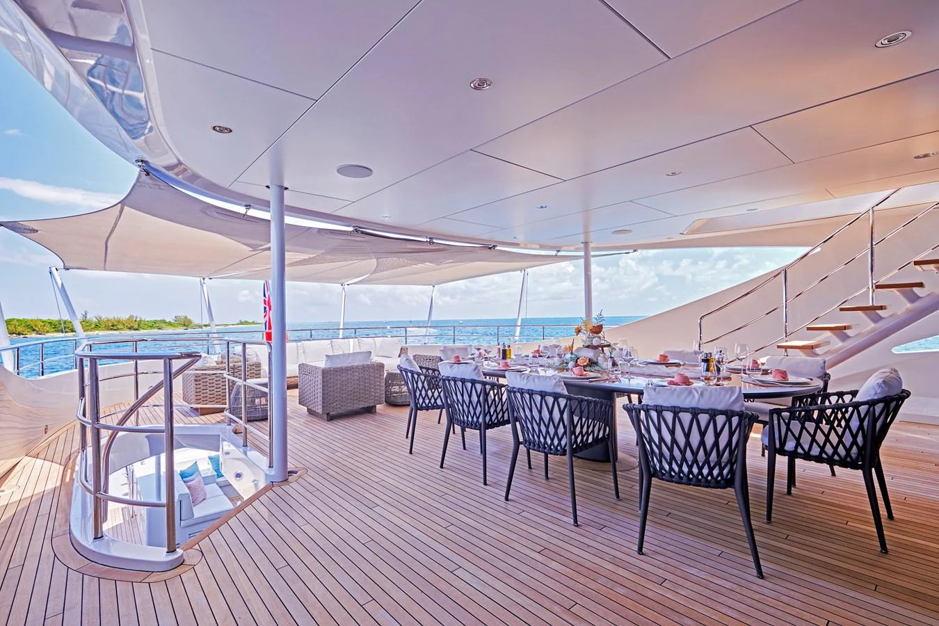 The aft deck features an elegant dining area with a stunning ocean view. aboard ARKADIA Yacht for Sale