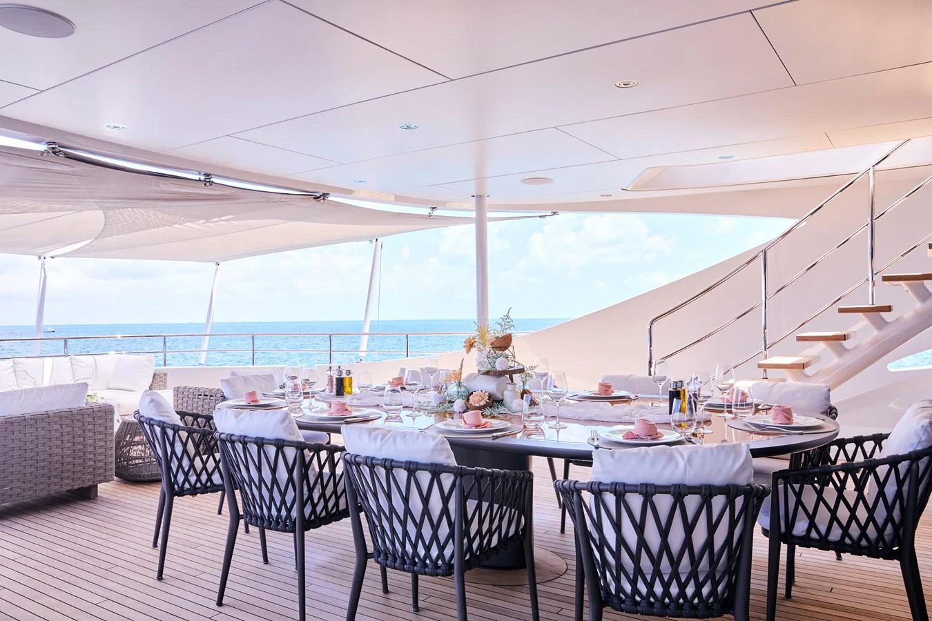 The alfresco dining area offers a luxurious and inviting space for outdoor meals with stunning ocean views. aboard ARKADIA Yacht for Sale