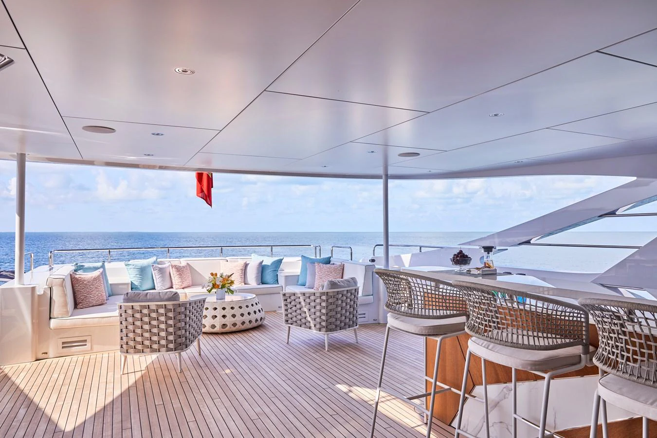 The aft deck features a stylish bar and comfortable seating with a stunning ocean view. aboard ARKADIA Yacht for Sale