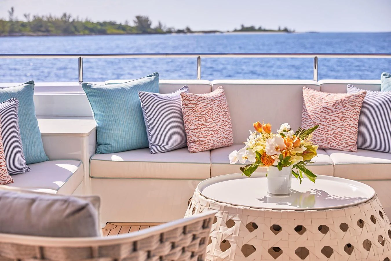 The aft deck features a comfortable seating area with plush cushions and a stylish table, perfect for enjoying the ocean view. aboard ARKADIA Yacht for Sale