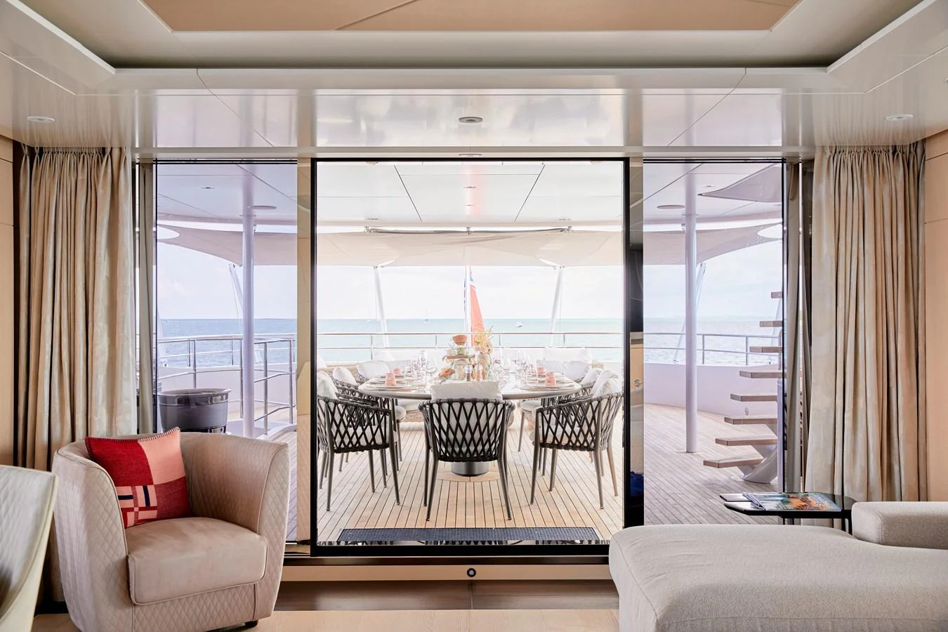 The salon opens up to an elegant outdoor dining area with a stunning ocean view. aboard ARKADIA Yacht for Sale