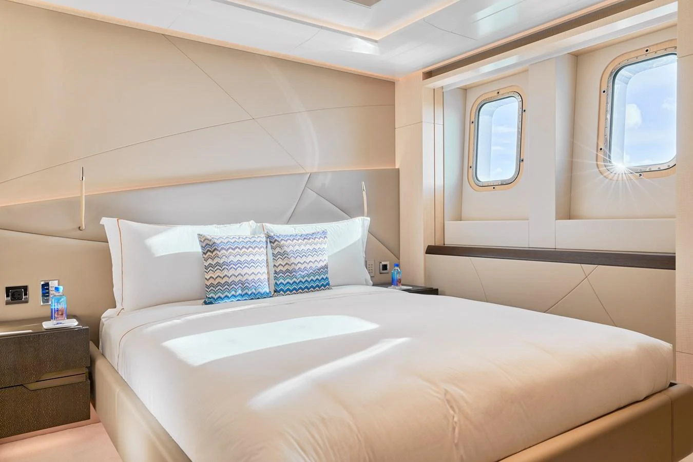 A luxurious stateroom with a large bed and natural light streaming through the windows. aboard ARKADIA Yacht for Sale