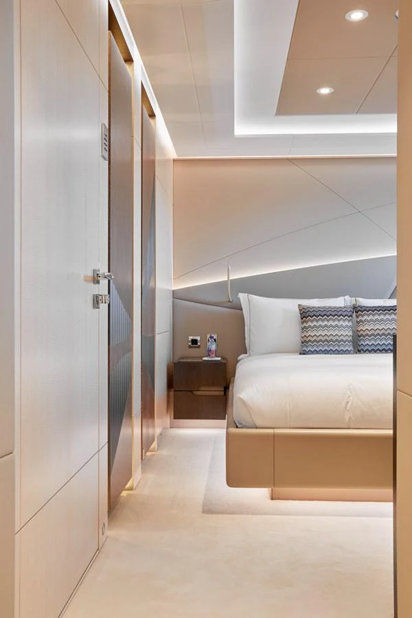 The stateroom features a modern design with elegant lighting and luxurious bedding. aboard ARKADIA Yacht for Sale