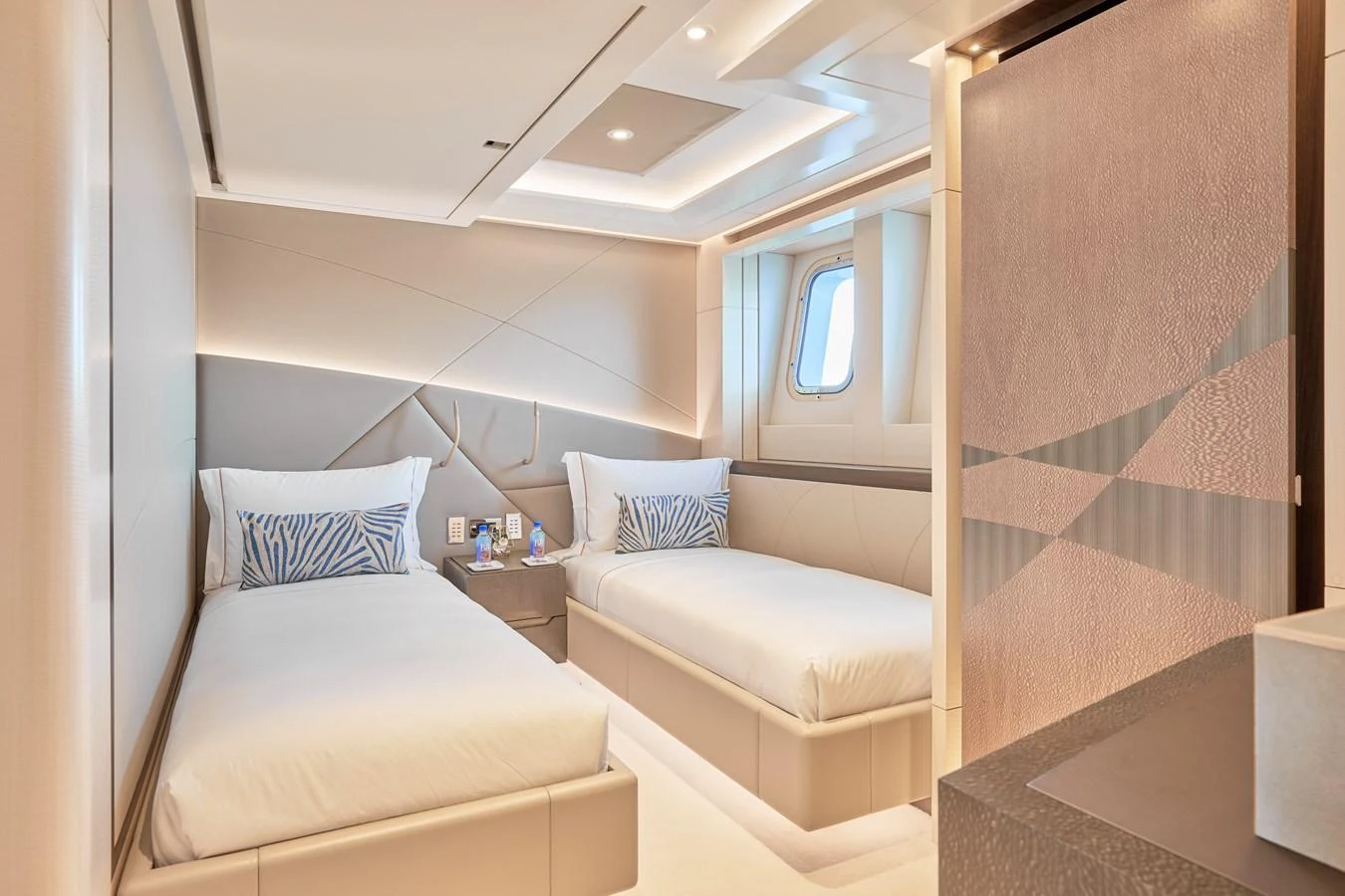 The guest stateroom features twin beds with modern, elegant decor and ample natural light. aboard ARKADIA Yacht for Sale