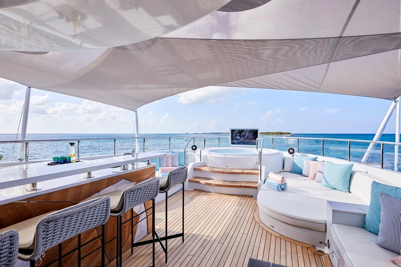 The sundeck offers a luxurious space with a bar, seating area, and jacuzzi, perfect for relaxation and entertainment. aboard ARKADIA Yacht for Sale