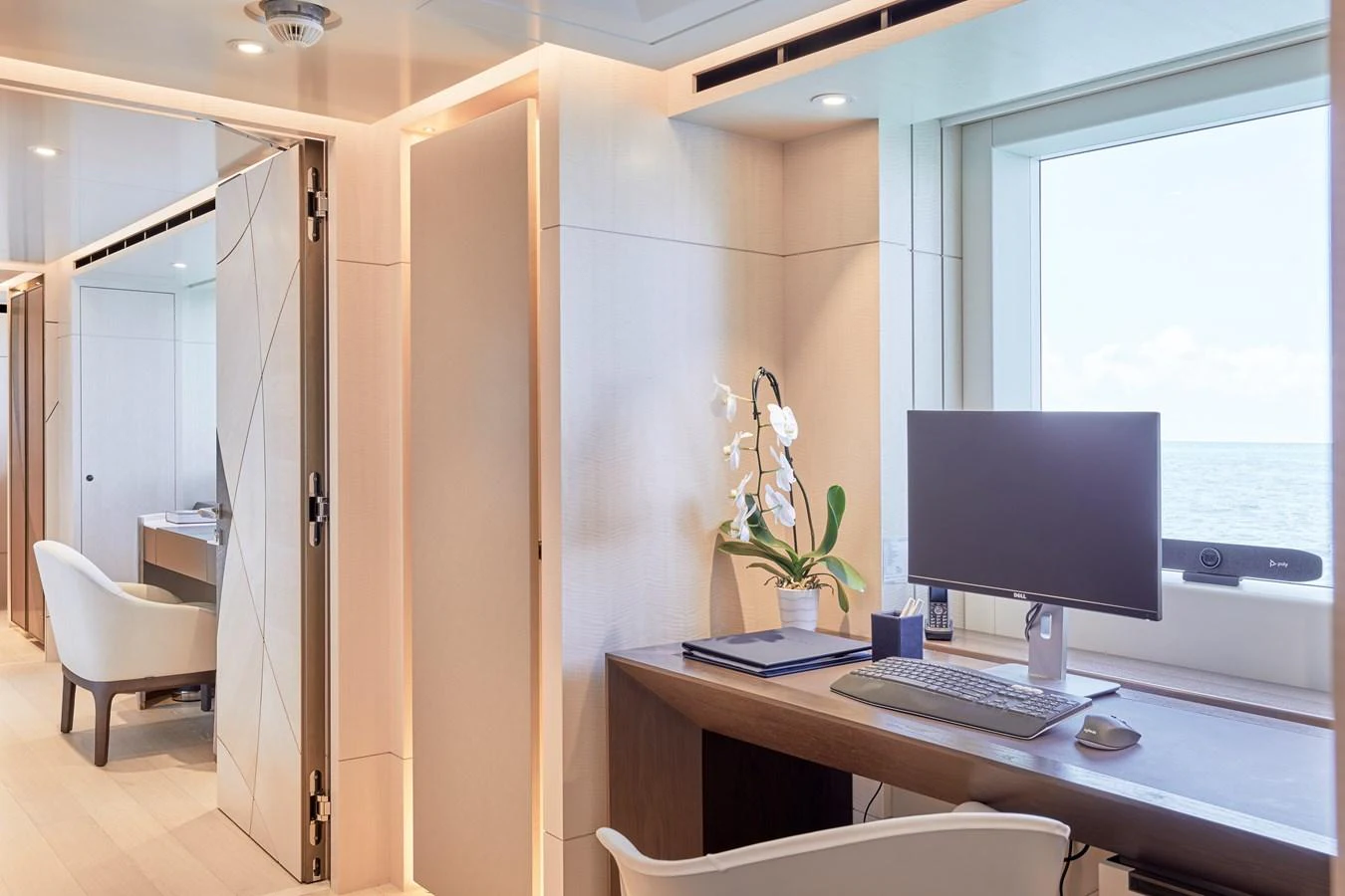 A serene onboard office space with a large window offering a view of the sea. aboard ARKADIA Yacht for Sale