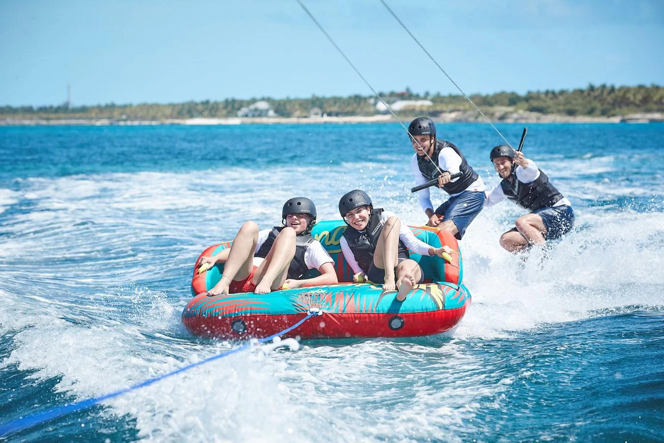 Guests enjoy an exhilarating ride on an inflatable water toy, towed by the yacht. aboard ARKADIA Yacht for Sale