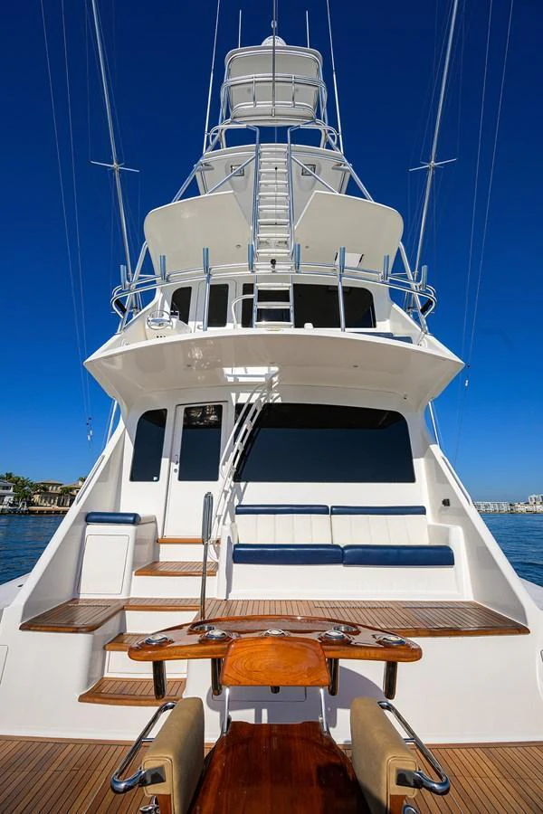 The yacht's impressive tower and aft deck are showcased against a clear blue sky. aboard WASABI Yacht for Sale