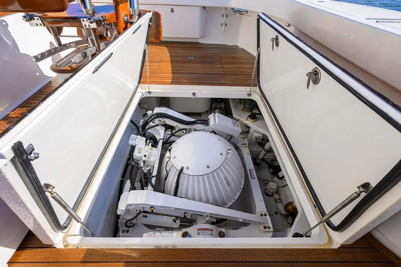 A detailed view of the yacht's engine compartment, showcasing the mechanical components and storage space. aboard WASABI Yacht for Sale
