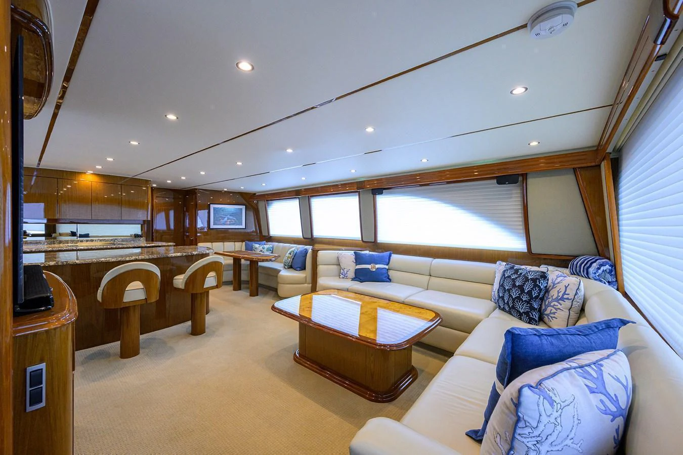 The salon features luxurious seating with elegant decor and ample natural light. aboard WASABI Yacht for Sale
