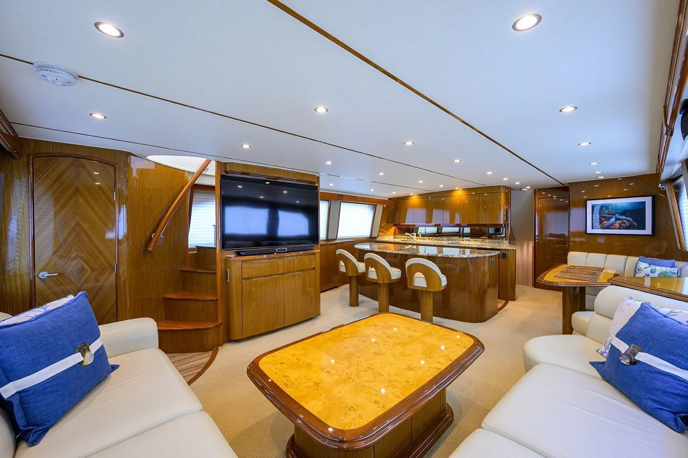 The yacht's salon features luxurious seating, a dining area, and a well-equipped entertainment center. aboard WASABI Yacht for Sale
