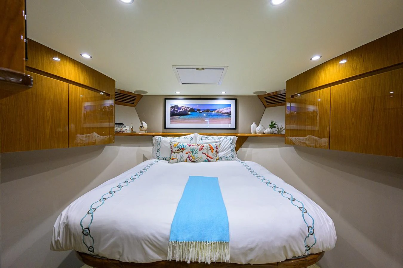 A cozy stateroom featuring a comfortable bed with elegant bedding and ample storage space. aboard WASABI Yacht for Sale