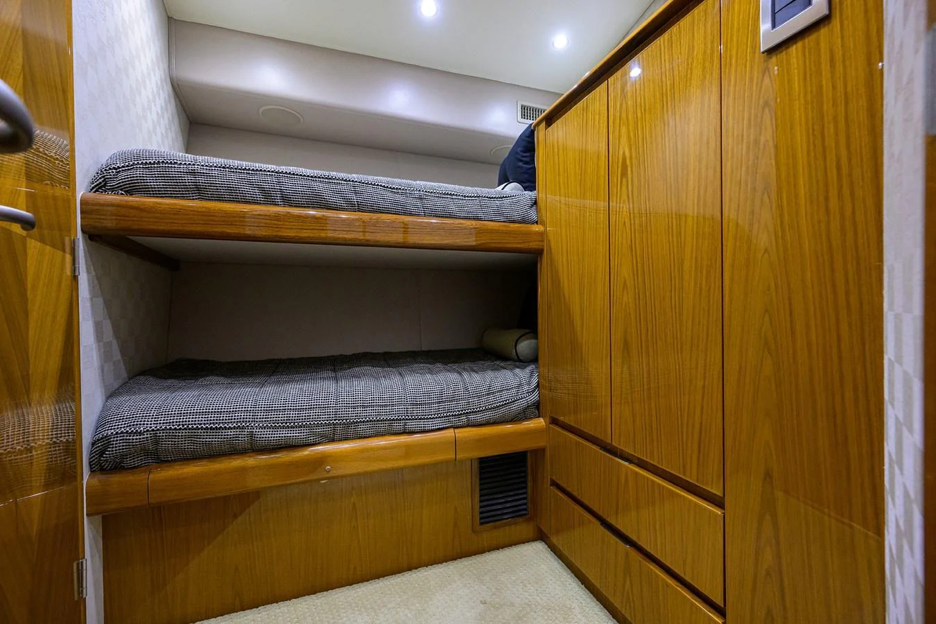The cozy bunk cabin features polished wood finishes and comfortable bedding. aboard WASABI Yacht for Sale