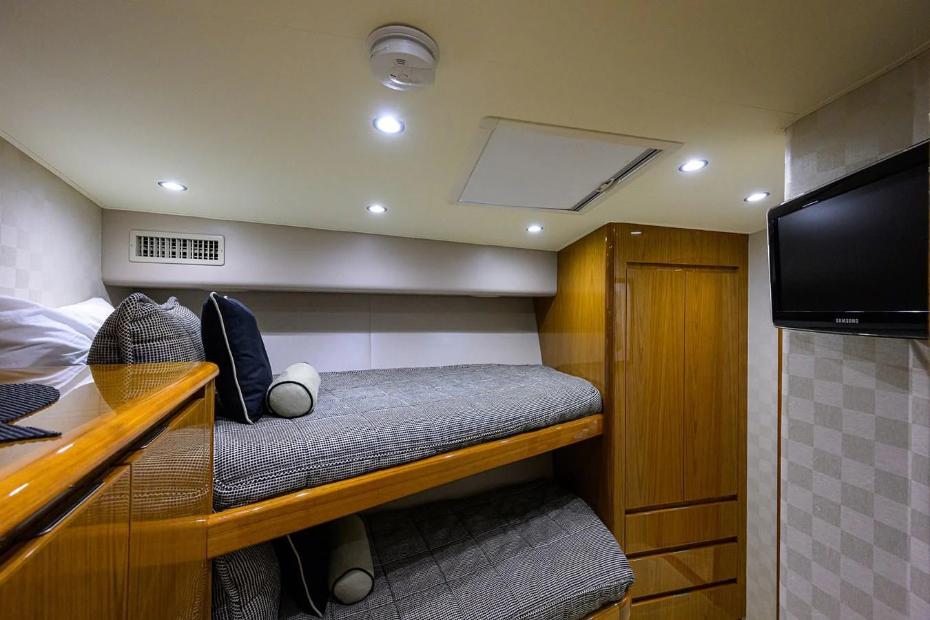 The guest cabin features cozy bunk beds and modern amenities for a comfortable stay. aboard WASABI Yacht for Sale