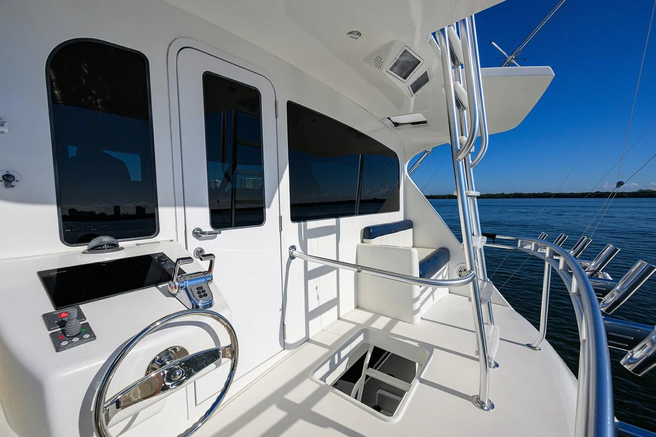 The yacht's helm station offers a sleek and modern control area with a stunning view of the water. aboard WASABI Yacht for Sale