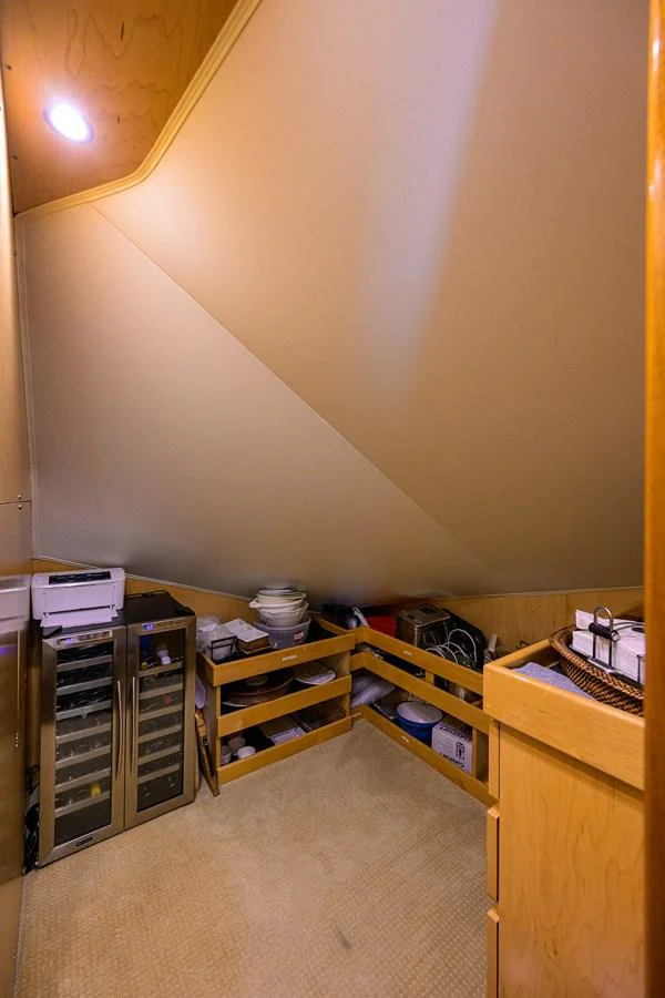 A cozy storage area with shelves and cabinets, perfect for organizing essentials. aboard WASABI Yacht for Sale