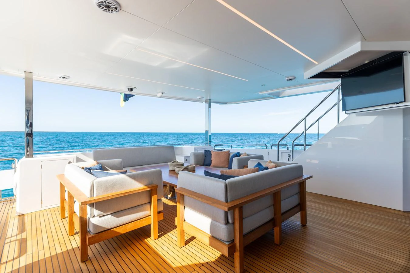 The aft deck features a comfortable seating area with a stunning ocean view. aboard NEX-T Yacht for Sale