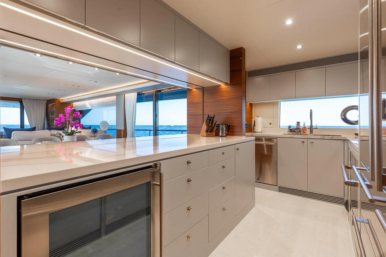 The yacht's galley features modern cabinetry, a sleek countertop, and ample natural light. aboard NEX-T Yacht for Sale