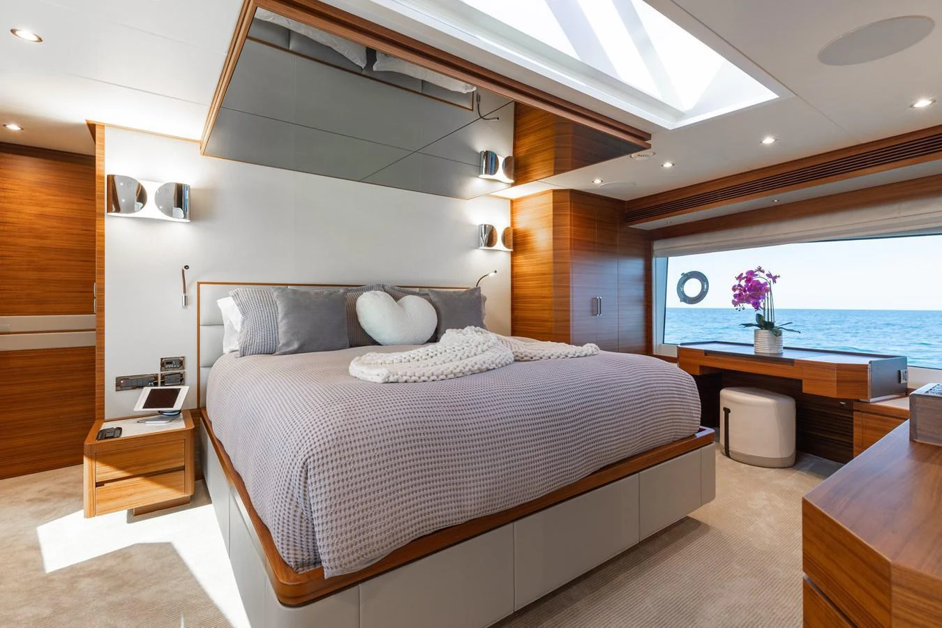The master stateroom features a luxurious bed with elegant decor and ample natural light. aboard NEX-T Yacht for Sale