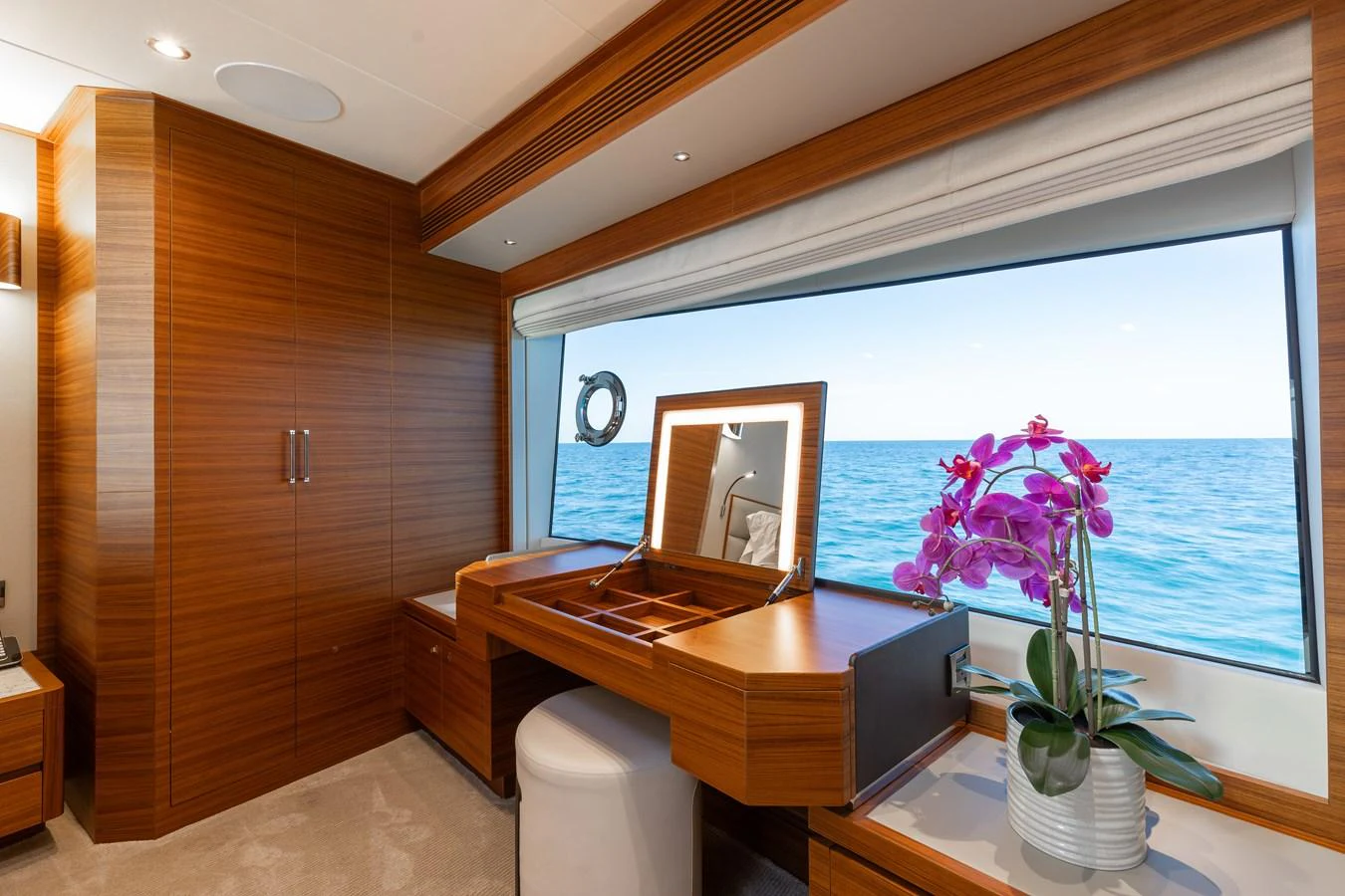 A luxurious vanity area with a large window offering a stunning ocean view. aboard NEX-T Yacht for Sale