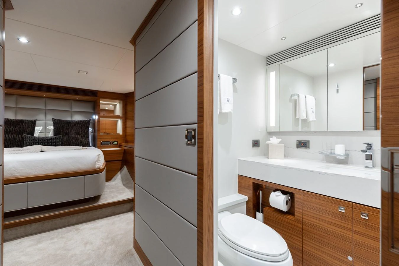 The image showcases a luxurious stateroom with an ensuite bathroom, featuring modern design and high-end finishes. aboard NEX-T Yacht for Sale