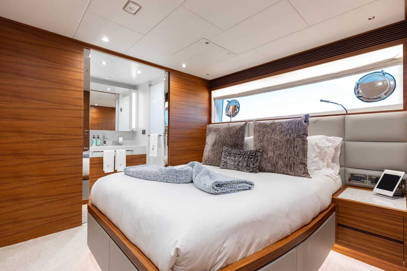 The master stateroom features a luxurious bed with plush pillows and a modern ensuite bathroom. aboard NEX-T Yacht for Sale